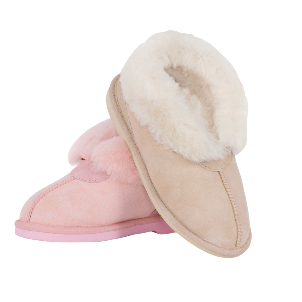 Pair of pink and beige slippers with Australian sheepskin, wool fur lining on a white background