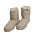 Pair of outdoor beige wool, Australian sheepskin suede boots with white fur lining on a white background